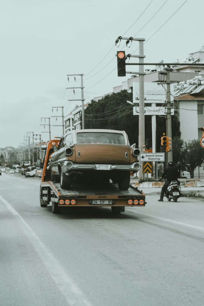 Veena Packers and Movers truck securely transporting a luxury car on Mumbai highways