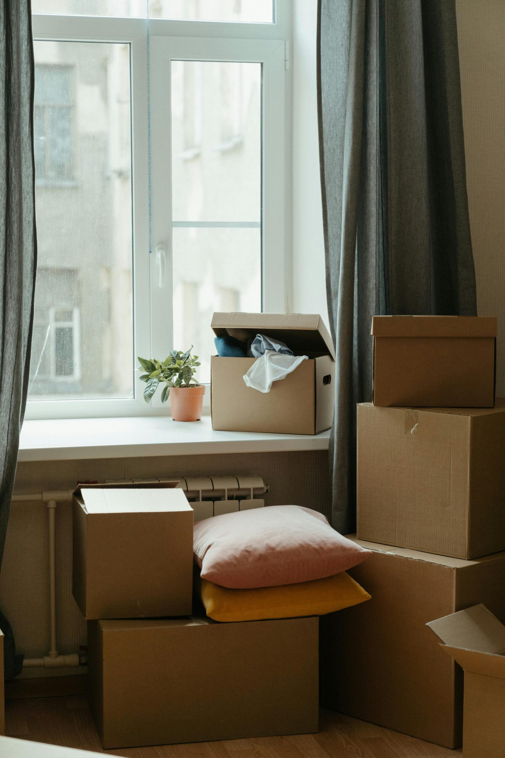 Veena Packers and Movers professional team packing household items in sturdy corrugated boxes for safe home relocation in Navi Mumbai